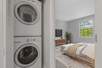 a bedroom with a washer and dryer  at Courthouse Square Apartments, Towson, 21286